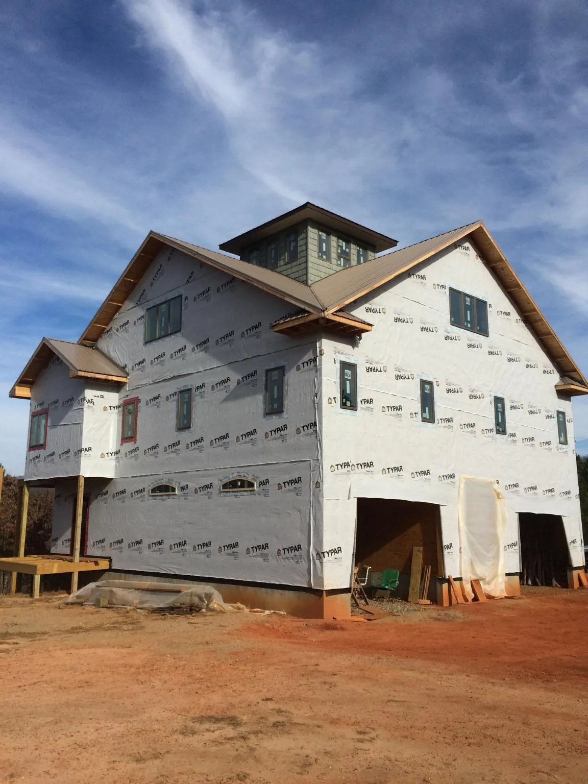 New two story house under construction with a cupola and gabled roofs in Howard